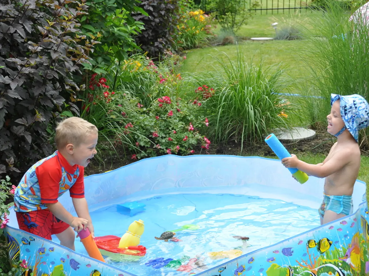 In the image we can see two children wearing clothes and they are playing with the water, this is a...