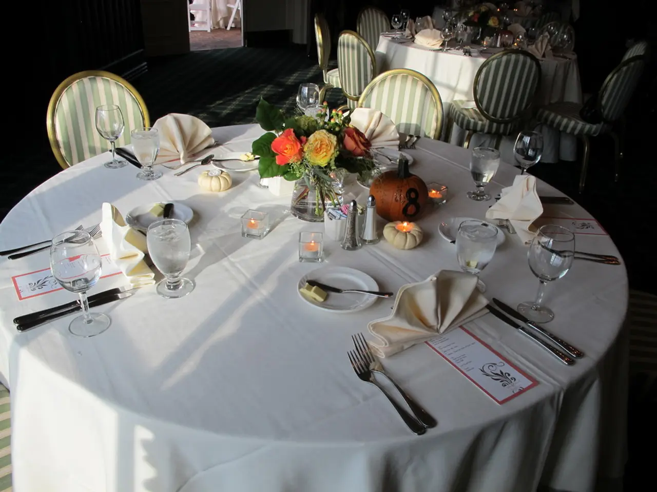 This is the picture of a dining tables which has chairs around them and on the table we can see a...