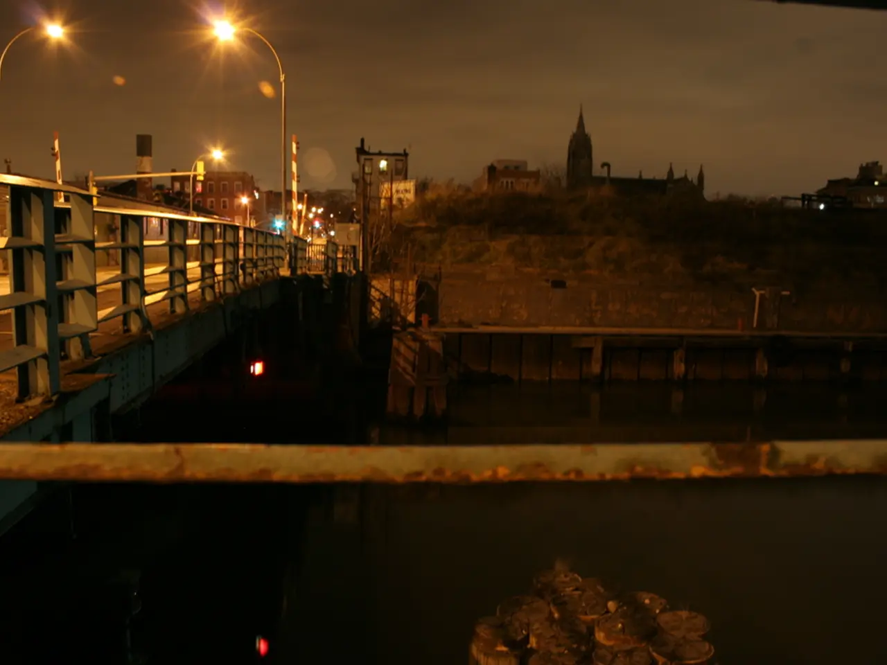 In the picture there is a bridge across the river and on the bridge there are many street lights,...