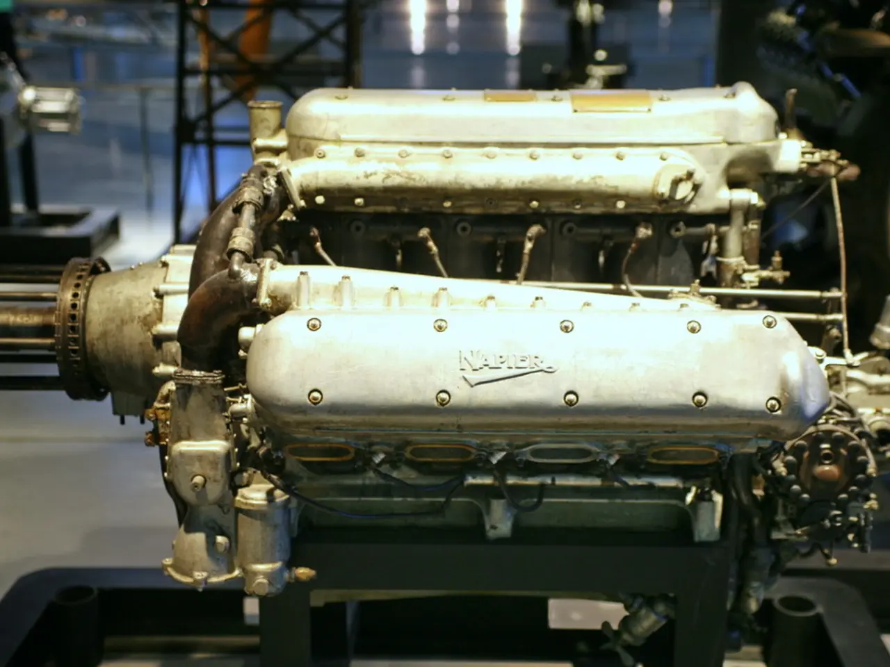 In this image there is a machine in the center with some text written on it. In the background...