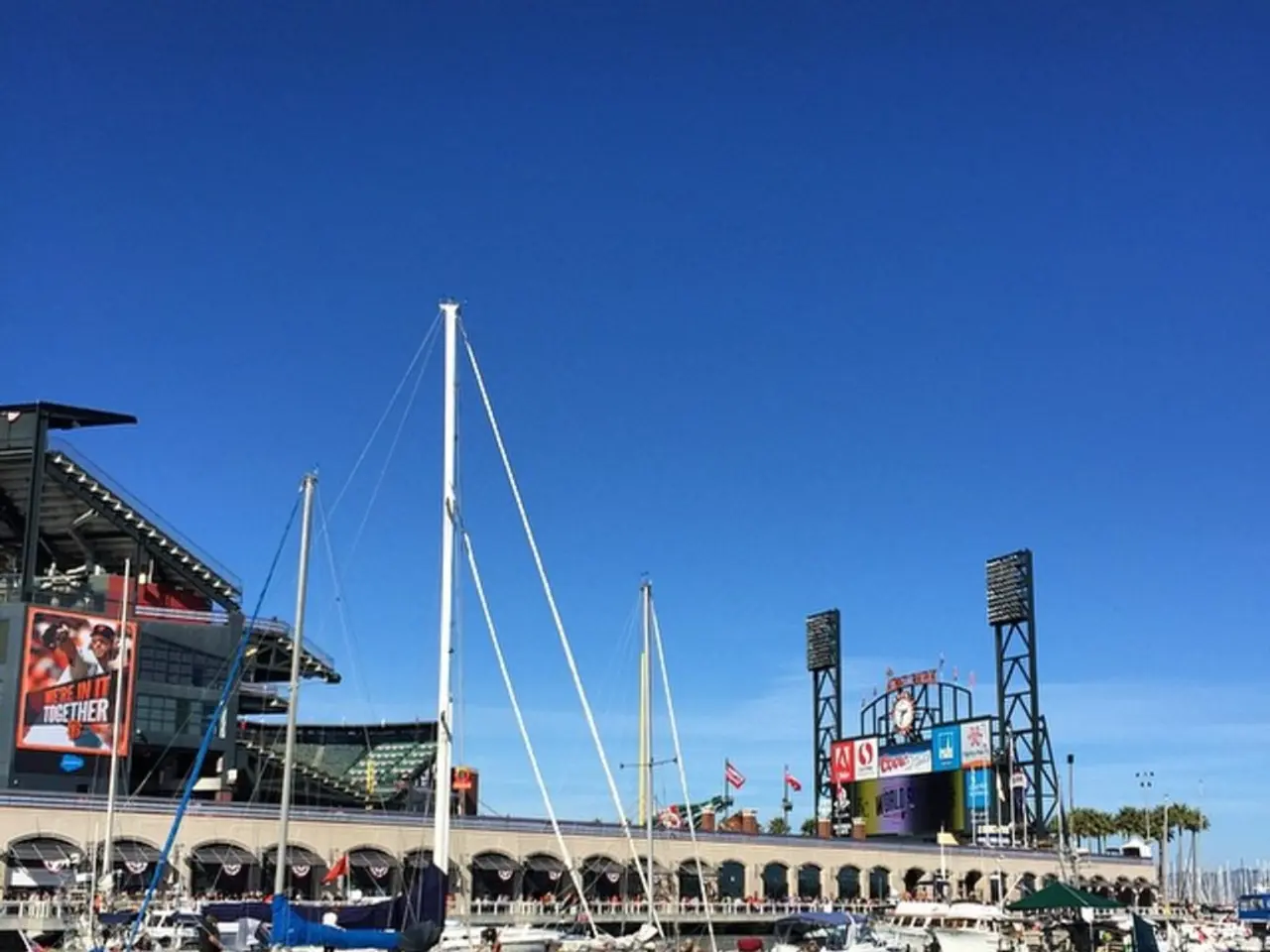 In the foreground of this image, there are many boats on the water. In the background, there is a...