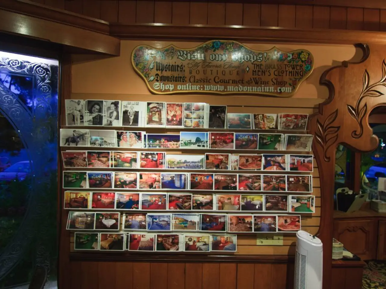 This picture shows a wooden board with some text and we see photos and we see a cupboard with some...