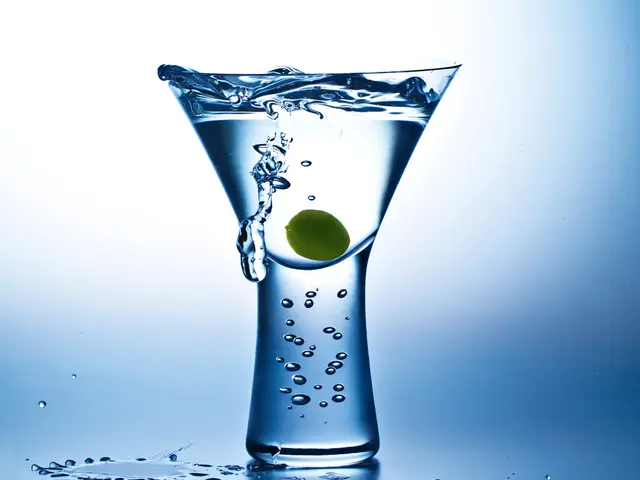 In this image there is a glass with water and an item inside the glass, there is a watermark on the...