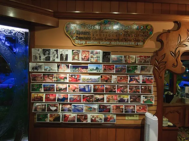 This picture shows a wooden board with some text and we see photos and we see a cupboard with some...