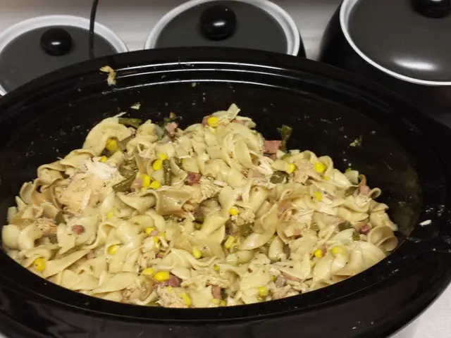 In this image there is a slow cooker truncated, there is food in the slow cooker, there is a wire...